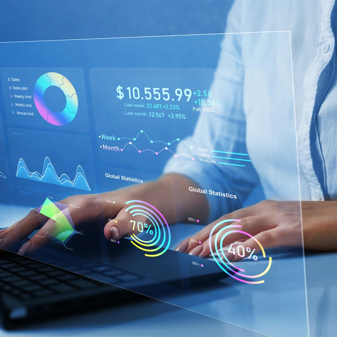 women using laptop with statistics and data visualizations holographically displayed image